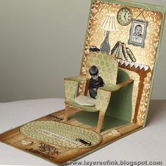 an open book with a miniature doll sitting in a chair