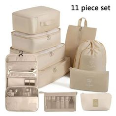 four pieces of white luggage with matching bags