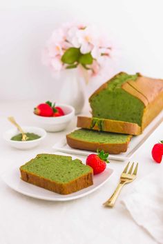 slices of bread with green toppings and strawberries on the side next to them