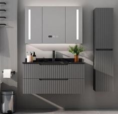 a kitchen with grey cabinets and black counter tops