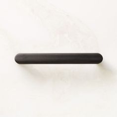 a black object on a white surface with no one around it or in the background