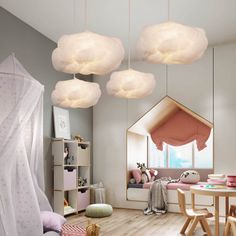 a child's room with pink and white decor, including clouds hanging from the ceiling