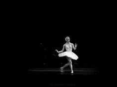 a ballerina in white tutu dancing on stage