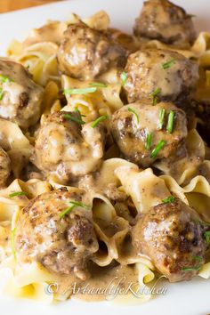 a white plate topped with meatballs and noodles