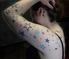 a woman with stars painted on her arm