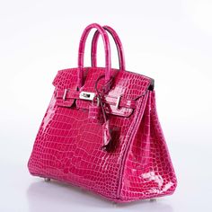 This Hermès Birkin 25 is an emblem of haute couture, a handbag that sings tales of luxury in every detail. This 2022 creation is a masterpiece, where the rare Porosus crocodile serves as a canvas for the vibrant Rose Mexico hue, an exquisite color that radiates with a vivacity as spirited as its namesake. Adorned with Palladium hardware, the metallic accents gleam with a cool brilliance, a stark yet harmonious contrast to the warm undertones of the crocodile. The glossy finish of the skin reflec Luxury Crocodile Pattern Bags For Gifts, Luxury Crocodile Pattern Bags As Gift, Crisp White Blouse, Hermes Kelly Bag, Hermes Birkin 25, Kelly Bag, Crocodile Skin, Birkin 25, Color Pairing