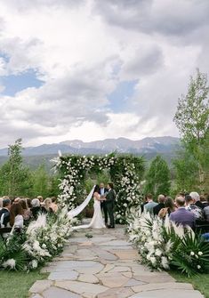 a bride and groom are standing at the end of their wedding ceremony with white flowers