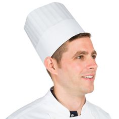 a man wearing a chef's hat and smiling at the camera