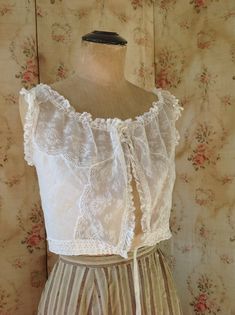 "breath taking fresh antique camisole, wedding top. sleeveless lace summer top in excellent condition. bust 92 cm 36\" waist 66 cm 26\" length 38 cm 15\" the shoulders have ruffled lace and made on them you can see see little roses made of soft silk ribbons" Lace Trim Sleeveless Corset, Lace Corset With Lace Trim Sleeveless, Sleeveless Lace Corset With Lace Top, Sleeveless Lace Patchwork For Summer, Summer Lace Corset With Lace Top Detail, Sleeveless Lace Bodice Summer Corset, White Lace Bodice With Lace Trim, White Vintage Lace Corset, White Vintage Corset With Lace Trim