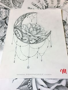 a drawing of a flower on top of a piece of paper with beads hanging from it