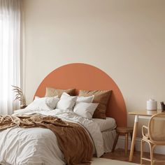 a bedroom with an orange circle on the wall