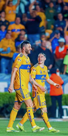 two soccer players are congratulating each other on the field