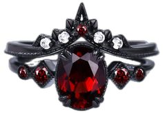 a close up of a ring with a red stone