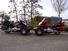 two motorcycles parked next to each other on the street