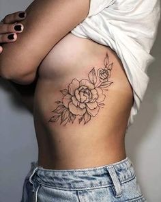 a woman with a flower tattoo on her stomach