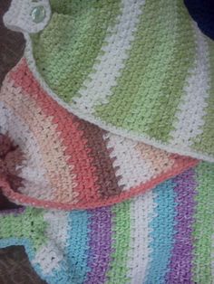 two crocheted baby blankets laying next to each other