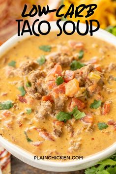 a white bowl filled with soup and topped with meat, cilantro and parsley