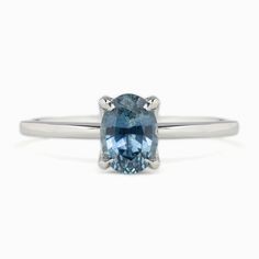 * One of a kind ring * In stock, ready to ship in size 7 * 1.06ct Oval Cut Montana Sapphire Blue 6.96x5.07x3.65mm Heated * Center stone clarity: si2-obvious inclusions that can be easily seen under 10x magnification. A slight effect on appearance and brilliance. * Center stone note: feather under the girdle * Bandwidth: approx. 1.4mm * High profile four prongs flower setting * Ethically sourced solid 14k white gold and gemstones * Packaged in a recyclable kraft ivory ring box Classic Sapphire Ring In 14k White Gold, Classic 14k White Gold Ring With Gemstone, Classic 14k White Gold Diamond Ring With Gemstone, Modern Sapphire Prong Setting Promise Ring, Classic 14k White Gold Diamond Ring, Classic White Gold Radiant Cut Topaz Ring, Classic Radiant Cut White Gold Topaz Ring, Silver Sapphire Promise Ring In 14k White Gold, Oval Sapphire Promise Ring In 14k White Gold