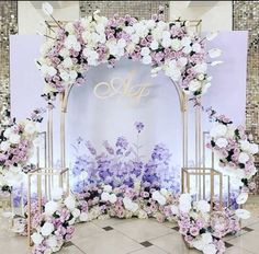 an arch decorated with white and pink flowers