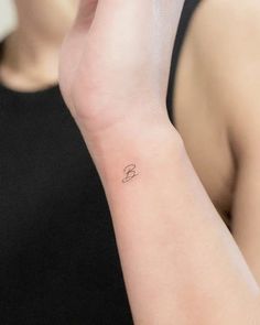 a woman with a small tattoo on her wrist