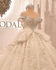 a white wedding dress on display in front of a wall with the word rodi