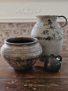 two vases sitting on top of a wooden table