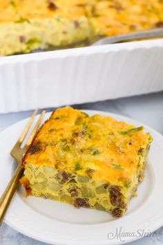 a white plate topped with a slice of quiche next to a casserole dish