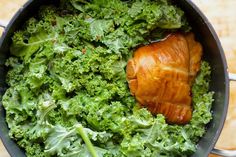 a pot filled with broccoli and meat on top of a table