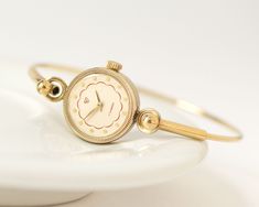 "Vintage lady's watch bracelet made by Uglich Watch Factory, pre-owned timepiece. Watch is in fully working order, professionally serviced, mechanical movement, manual winding, 17 jewels. The tiny bracelet is a ring type, fits for the small wist about 6.4\" (16,5 cm) in circumference. Made in USSR. Year: 1990s The case measures: 0.6\" (1,7 cm) in diameter. Complimentary gift wrapping included. Thanks for checking out my listing, let me know if you have any other questions. Express shipping world Dainty Watches For Women, Tiny Watch, Tiny Bracelet, Watches Women Simple, Ethereal Style, Cocktail Watch, Vintage Gold Watch, Ladies Bracelet Watch, Lady Watch