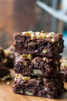 three brownies stacked on top of each other with nuts and chocolate chips in the middle