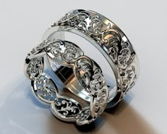 two silver rings with intricate designs on them