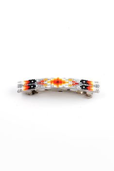 an orange, black and white beaded hair clip