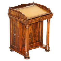 an old fashioned wooden desk with writing on the top and bottom panel, inlaid to wood