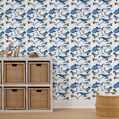 a blue and white wallpaper with fish on it, next to some wicker baskets