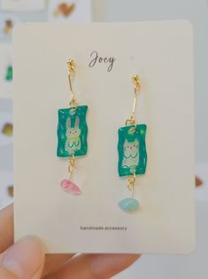 About Joey Joey is an original handcrafted jewelry brand known for its playful and cute designs. The designer expertly uses materials like polymer clay, shrink plastic, resin, and clay to create whimsical pieces. From shrink plastic bird earrings to polymer clay animal-shaped studs and resin apple rings, each piece is full of charm and creativity. 🐼More Joey's Products👈 Product Detail Material: Plastic, UV, Resin, 18k Gold Plated Brass(Needle)Tech: HandmadeStyle: Cute/Chill/CasualOccasion: Daily/Weekend Casual/Going Out/Travel/ShoppingProduct Note: 1. All pictures are taken in real-life scenarios, and color variations may exist under different lighting conditions. 2. This product is expected to take 5-8 days to produce, please understand!3. This is a model picture of the piece you will r Cute Everyday Green Jewelry, Handmade Polymer Clay Earrings For Birthday, Playful Hand Painted Resin Earrings, Playful Hand Painted Dangle Earrings, Cute Hand Painted Resin Earrings, Playful Resin Dangle Earrings, Playful Hand-painted Dangle Earrings, Handmade Playful Resin Jewelry, Quirky Resin Jewelry For Gifts