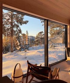 a living room filled with furniture next to a large window covered in frosty snow