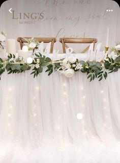 a table with flowers and candles on it for a wedding or special event decorated with tulle