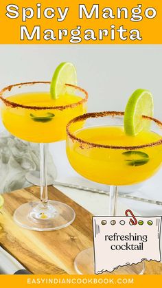 two glasses filled with orange margaritas on top of a cutting board