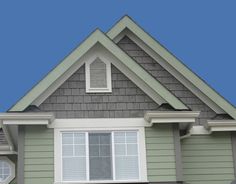 a gray house with white trim and windows