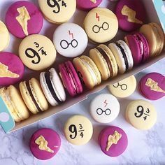 a box full of harry potter macaroons with numbers on them and some cookies in the middle