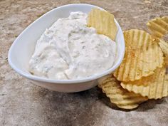 a bowl of dip and chips on a table