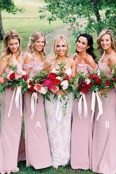 a group of women standing next to each other holding bouquets in their hands and wearing pink dresses