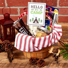 a basket filled with food sitting on top of a wooden table next to pine cones