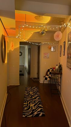 the hallway is decorated with lights and zebra rugs