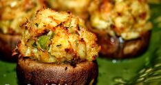 several stuffed mushrooms on a green plate