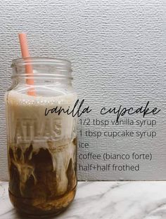 a glass jar filled with liquid sitting on top of a marble counter next to a white wall