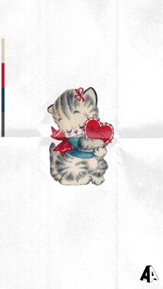 a kitten with a heart on it's chest holding a red object in its paws