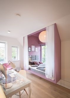 there is a mirror in the room that has been decorated with pink and white furniture