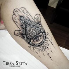 a black and white tattoo on the leg of a woman with an owl in her hand