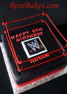 a birthday cake with the wwe logo on it